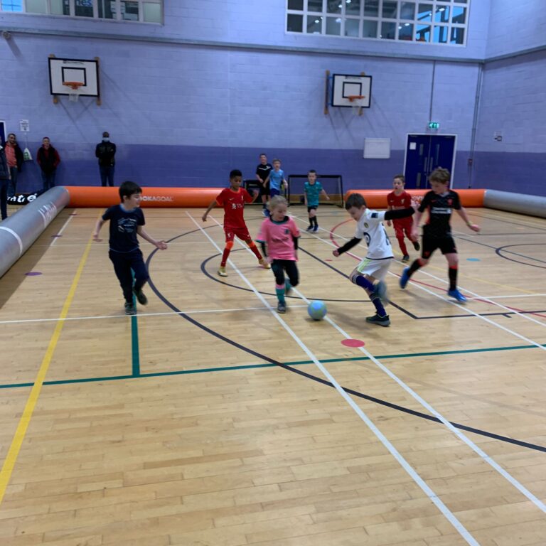 Children playing a birthday party game inside a Foot-Tech inflatable AirPitch