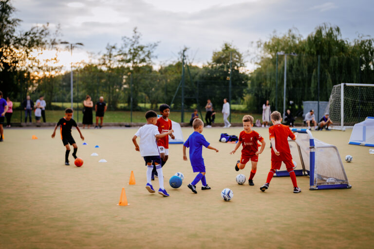 Children playing a small-sided game at Foot-Tech group training