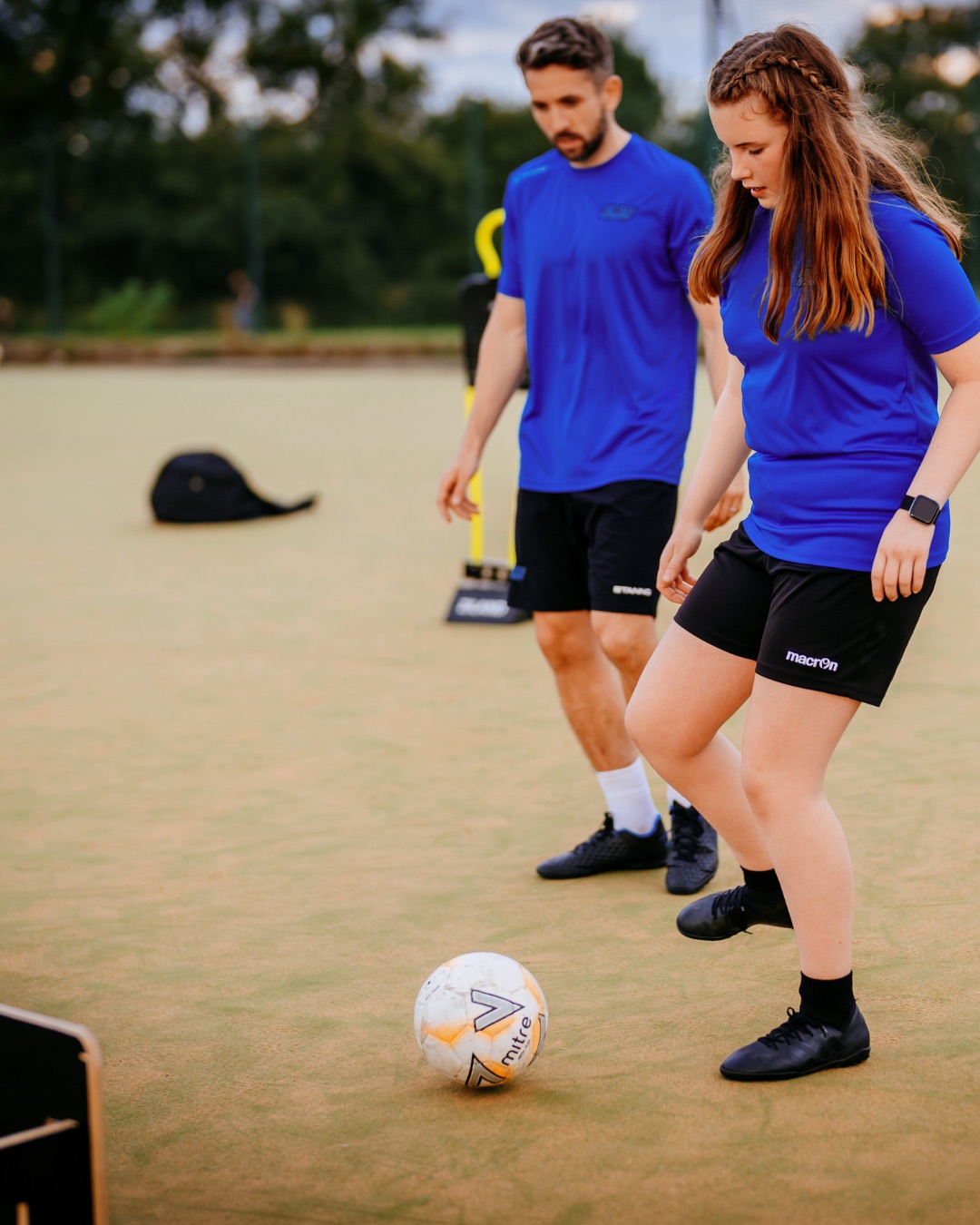A Foot-Tech coach and a young player working on close control in a 1-to-1 session